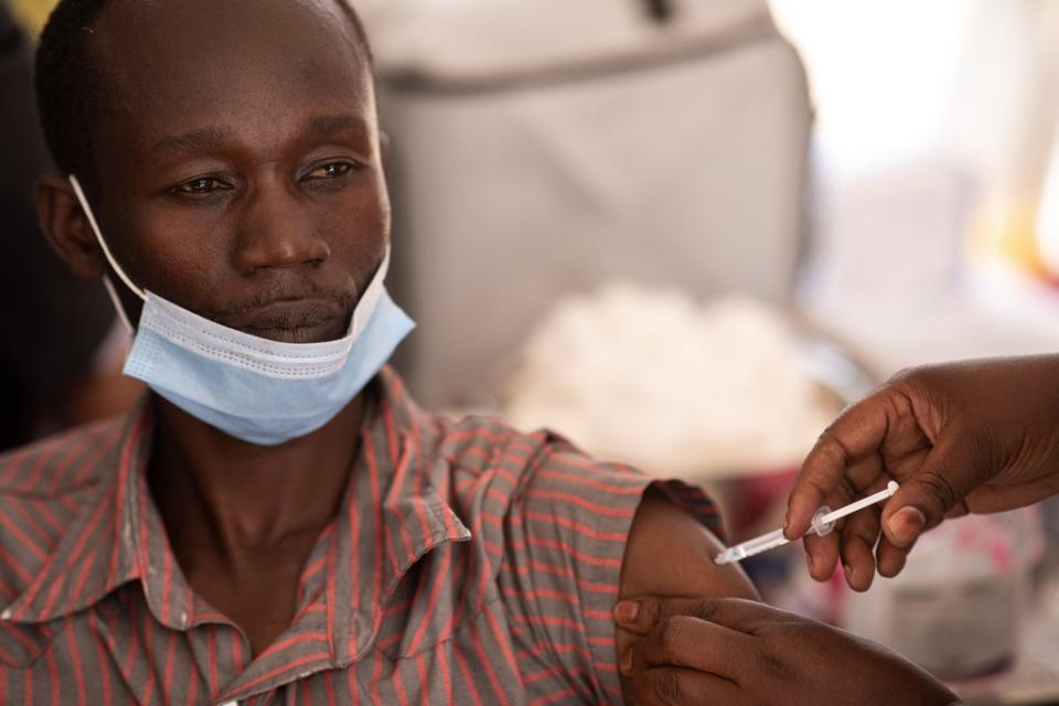 A healthcare professional is vaccinated against COVID-19  in Uganda (Getty Images)