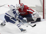 Washington Capitals goalie Vitek Vanecek (41) blocks a shoot by Toronto Maple Leafs' Ilya Mikheyev, left, during the third period of an NHL hockey game Monday, Feb. 28, 2022, in Washington. (AP Photo/Luis M. Alvarez)