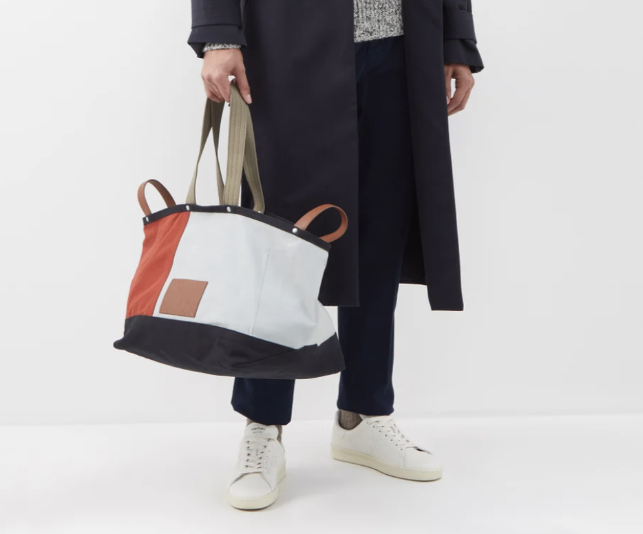 A model carrying Paul Smith Colour-block canvas tote bag.