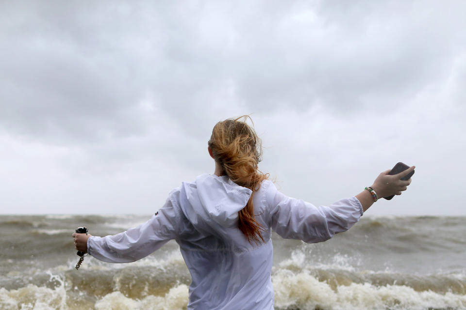 Audrey Ulfers stands on the shore of Lake Pontchartrain during Hurricane Barry in Mandeville, Louisiana, U.S. July 13, 2019.  REUTERS/Jonathan Bachman