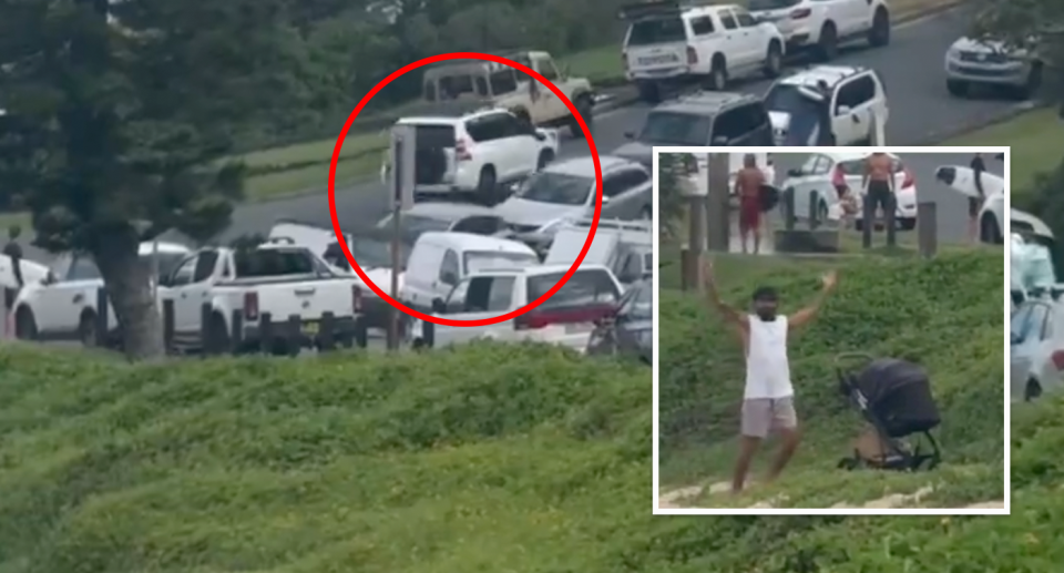 Pictured is the 4WD fleeing in the distance with a man, apparently the car's owner, watching on in dismay at Duranbah Beach. 