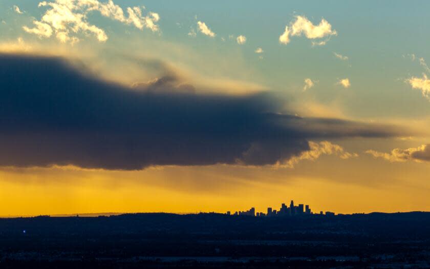 Glendora, CA - January 03: Storm clouds move on over downtown Los Angeles after rainfall totals of a quarter to one half inch of precipitation overnight on Wednesday, Jan. 3, 2024 in Glendora, CA. (Brian van der Brug / Los Angeles Times)