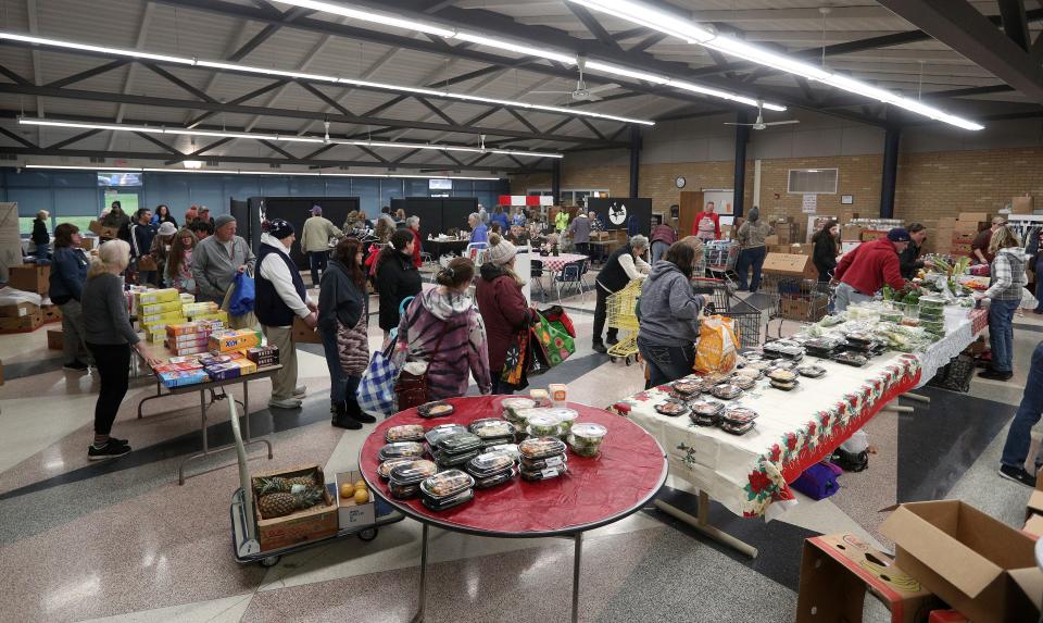 A line forms on a Saturday at the Sent By Ravens Food Pantry in Livonia.  Many grocery and retail stores in the area donate food to local food pantries and farms in their communities. 