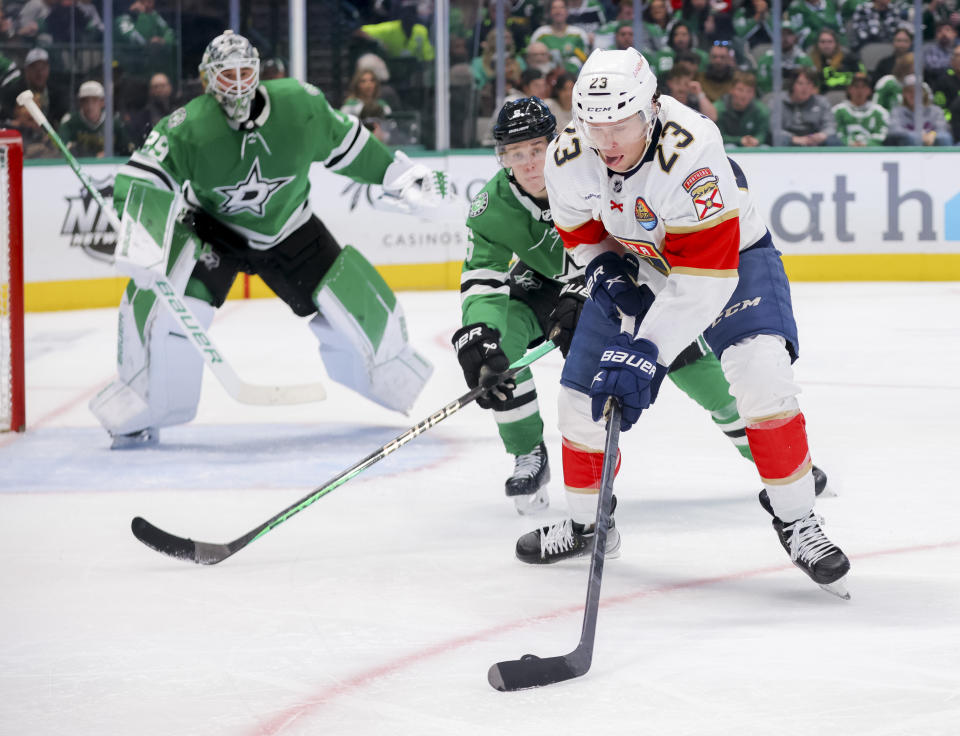 Florida Panthers center Carter Verhaeghe (23) shoots against Dallas Stars defender Nils Lundkvist, center, in the second period of an NHL hockey game in Dallas, Sunday, Jan. 8, 2023. (AP Photo/Gareth Patterson)