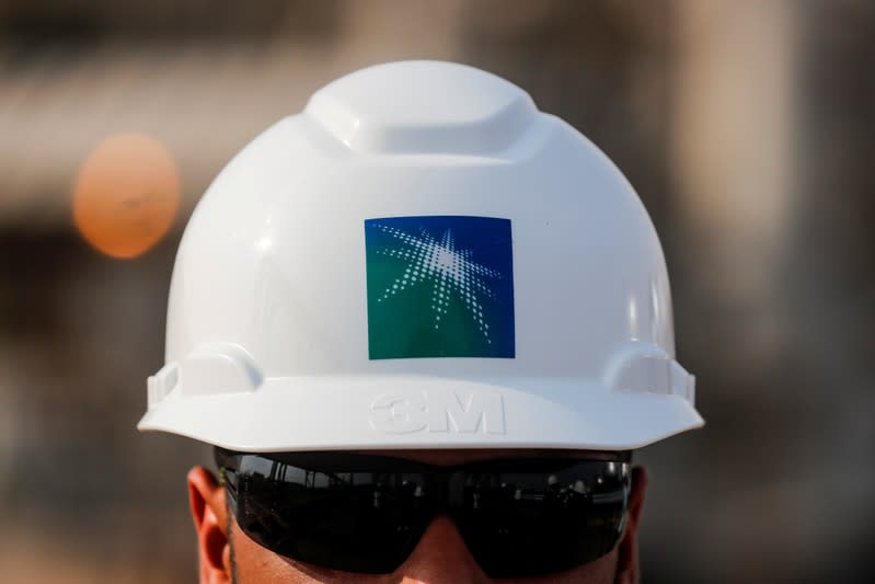 FILE PHOTO: FILE PHOTO: An employee in a branded helmet is pictured at Saudi Aramco oil facility in Abqaiq