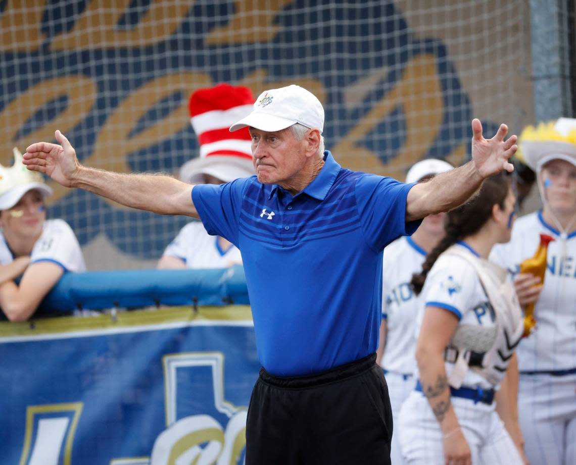 Boswell asst. coach Hank Fulkerson signals onto the field during a high school softball game at Boswell High School in Saginaw, Texas, April 16, 2024.