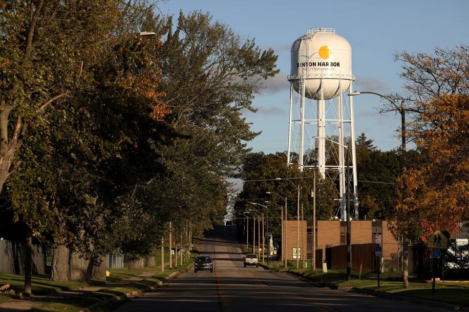 The setting sun lights up the Benton Harbor water tower on Britain Avenue on Oct. 26, 2021. Recently, Gov. Gretchen Whitmer has called for spending $20 million in Benton Harbor to replace nearly 6,000 service lines, most suspected of containing lead, within five years.