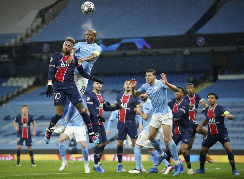 PSG's Neymar, left, challenges Manchester City's Fernandinho during the Champions League semifinal second leg soccer match between Manchester City and Paris Saint Germain at the Etihad stadium, in Manchester, Tuesday, May 4, 2021. (AP Photo/Dave Thompson)