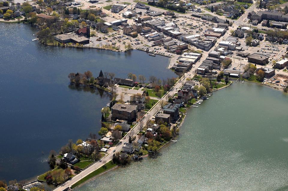 An aerial view in 2012 shows downtown Oconomowoc and portions of Fowler Lake and Lac La Belle. Oconomowoc's name is derived from a Potawatomi word meaning "gathering of the waters."