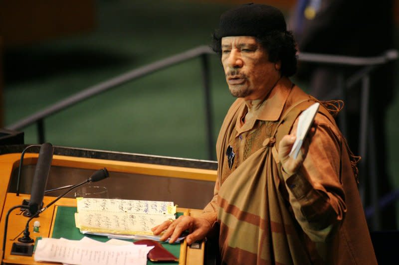 Libyan leader Moammar Gadhafi holds a book as he addresses the 64th General Assembly at the United Nations on September 23, 2009, in New York City. On October 20, 2011, the deposed dictator was killed as he tried to escape from his hometown hideout in the coastal city of Sirte. File Photo by Monika Graff/UPI