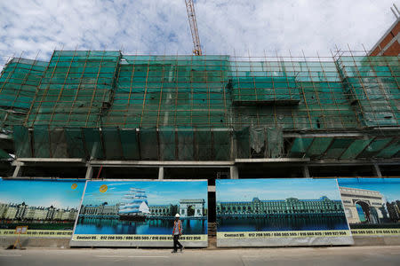 A construction work walks at the construction side in Diamond Island also known as 'Koh Pich' in Phnom Penh, Cambodia, May 23, 2018. Picture taken May 23, 2018. REUTERS/Samrang Pring