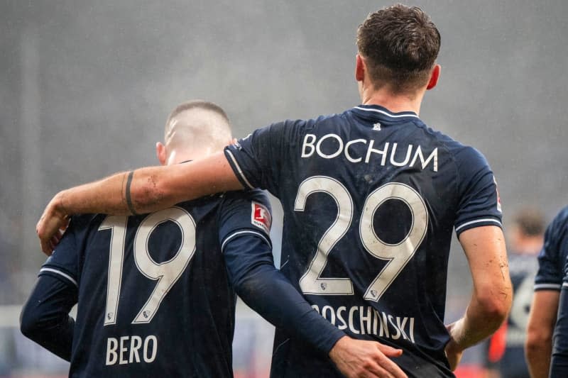 Bochum's Moritz Broschinski (R) celebrates scoring his side's first goal with teammate Matus Bero (L) during the German Bundesliga soccer match between VfL Bochum and FC Augsburg at the Vonovia Ruhrstadion. David Inderlied/dpa