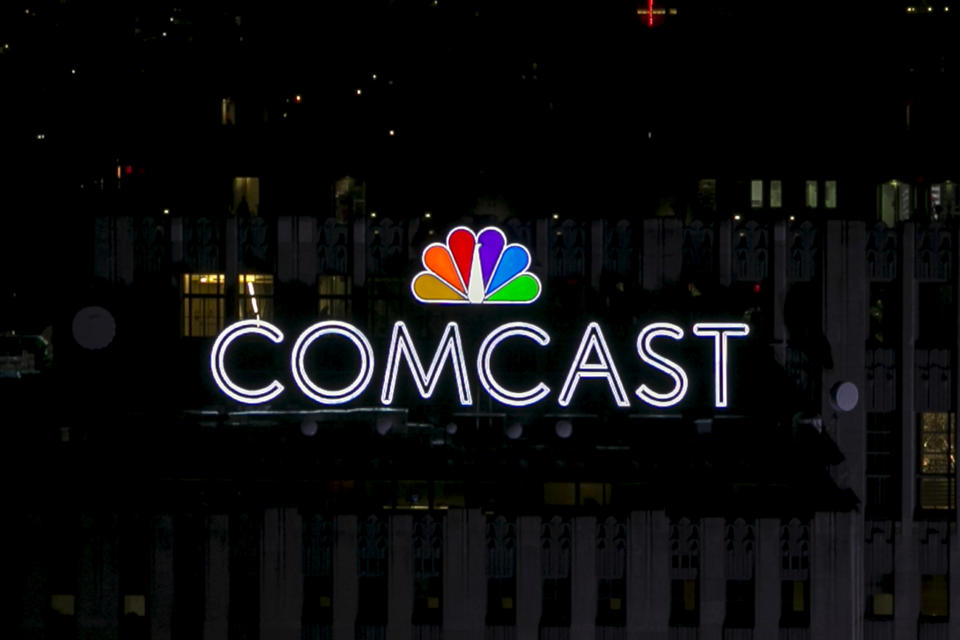 FILE PHOTO: The NBC and Comcast logo are displayed on top of 30 Rockefeller Plaza, formerly known as the GE building, in midtown Manhattan in New York