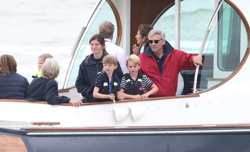 COWES, ENGLAND - AUGUST 08: Michael Middleton and Prince George watch the inaugural King’s Cup regatta hosted by the Duke and Duchess of Cambridge on August 08, 2019 in Cowes, England. Their Royal Highnesses hope that The King’s Cup will become an annual event bringing greater awareness to the wider benefits of sport, whilst also raising support and funds for Action on Addiction, Place2Be, the Anna Freud National Centre for Children and Families, The Royal Foundation, Child Bereavement UK, Centrepoint, London’s Air Ambulance Charity and Tusk. (Photo by Chris Jackson/Getty Images)