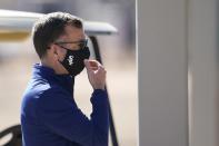 Chicago White Sox general manager Rick Hahn adjusts his face covering as he watches players during baseball spring training Wednesday, Feb. 24, 2021, in Phoenix. (AP Photo/Ross D. Franklin)