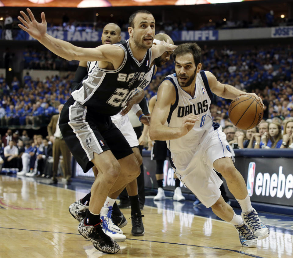 San Antonio Spurs' Manu Ginobili (20), of Argentina, defends against a drive to the basket by Dallas Mavericks' Jose Calderon, of Spain, in the first half of Game 6 of an NBA basketball first-round playoff series on Friday, May 2, 2014, in Dallas. (AP Photo/Tony Gutierrez)