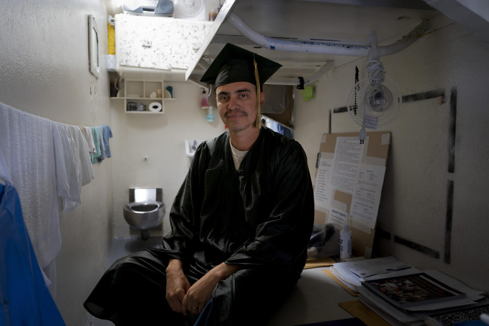 David Dominguez, who earned a bachelor's degree in communications through the Transforming Outcomes Project at Sacramento State (TOPSS), sits for a portrait in his cell after a graduation ceremony at Folsom State Prison in Folsom, Calif., Thursday, May 25, 2023. (AP Photo/Jae C. Hong)
