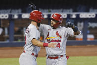 St. Louis Cardinals designated hitter Matt Carpenter (13) congratulates Yadier Molina (4) after Molina hit a home run in the seventh inning of a baseball game against the Miami Marlins, Wednesday, April 7, 2021, in Miami. (AP Photo/Marta Lavandier)