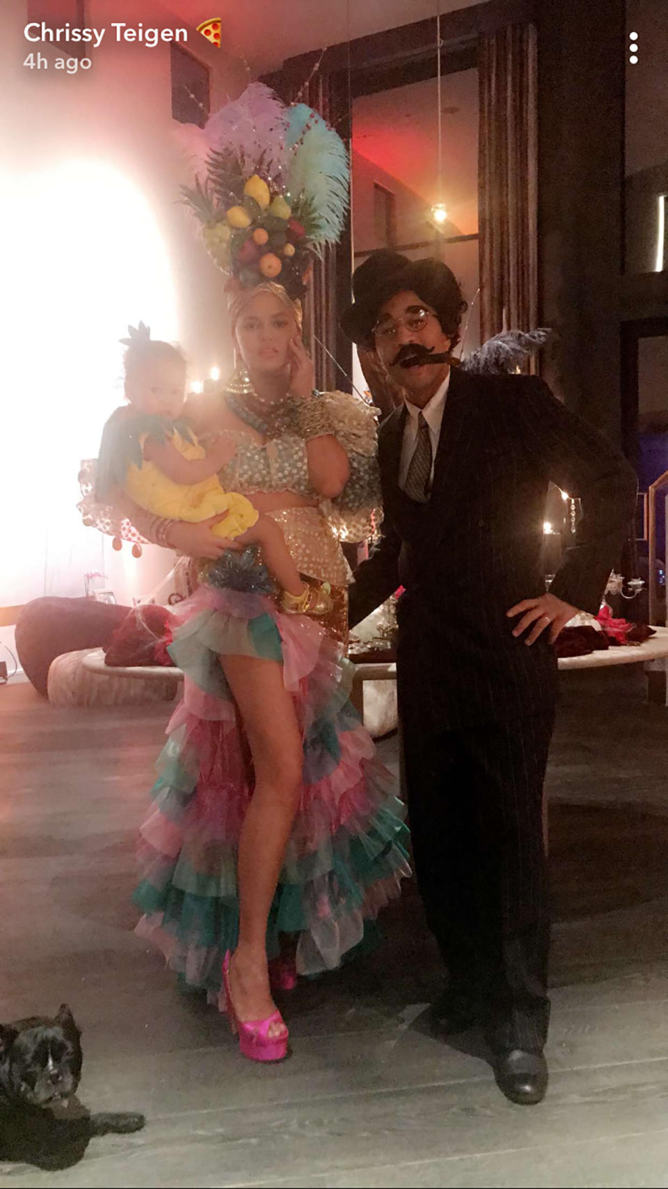 <p>How do you like that pineapple? The model was Carmen Miranda, so it only made sense that her mini-me, Luna, was something fruity. As for John Legend, he was Miranda’s <i>Copacabana </i>co-star Groucho Marx — stache and all. (Photo: Chrissy Teigen via Snapchat) </p>