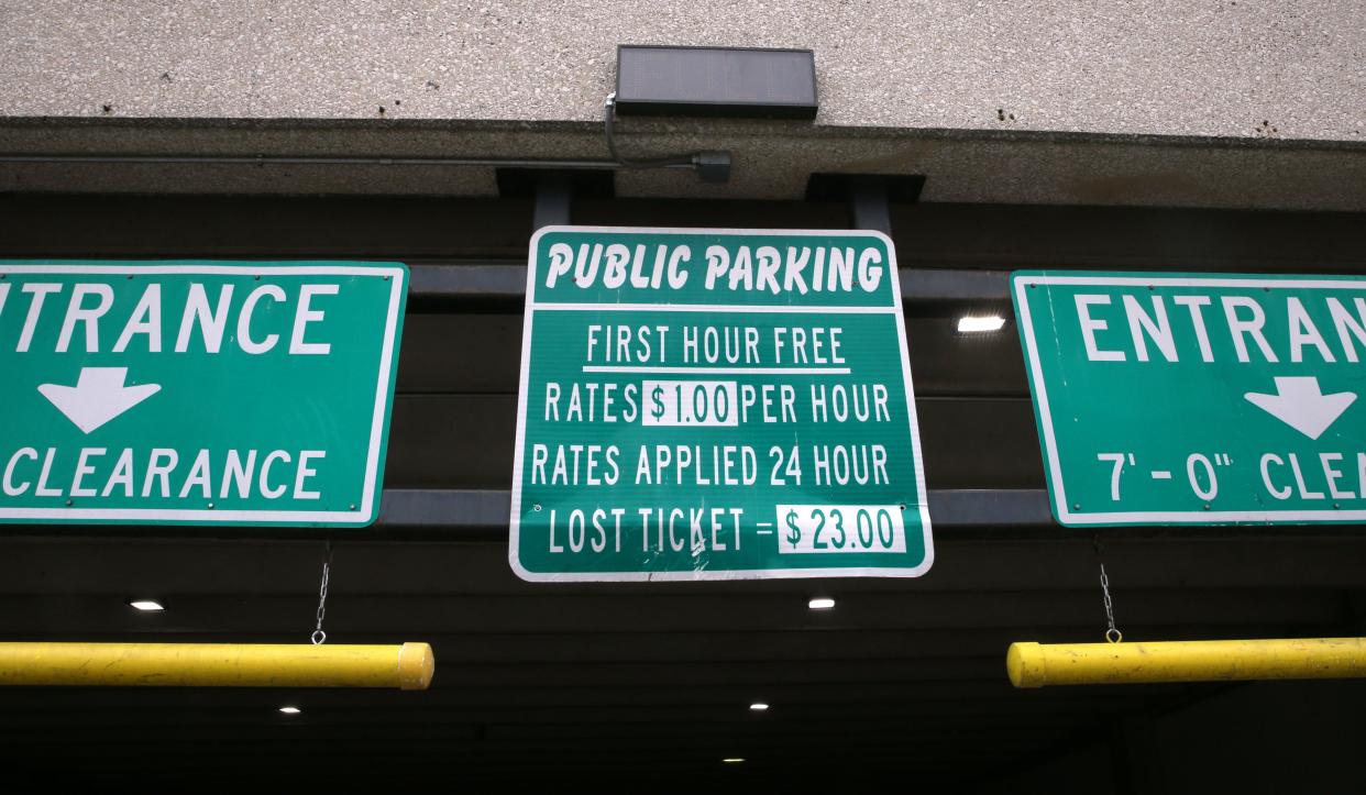 A parking fee sign is pictured on a parking structure Sunday, June 2, 2024 in downtown Iowa City, Iowa.