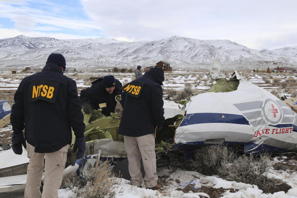 This photo provided by The National Transportation Safety Board shows NTSB investigators on Sunday, Feb. 26, 2023, at the crash site in Dayton, Nev., documenting the wreckage of a Pilatus PC-12 airplane a medical air transport flight operated by Guardian Flight that crashed on Friday, Feb. 24, while enroute from Reno, Nevada, to Salt Lake City. (NTSB via AP)