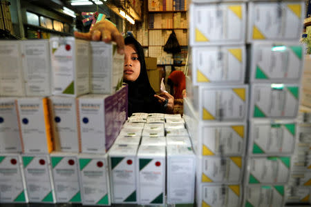 A shopkeeper arranges medicines to sell at a wholesale market in Jakarta, Indonesia, February 15, 2019. REUTERS/Willy Kurniawan