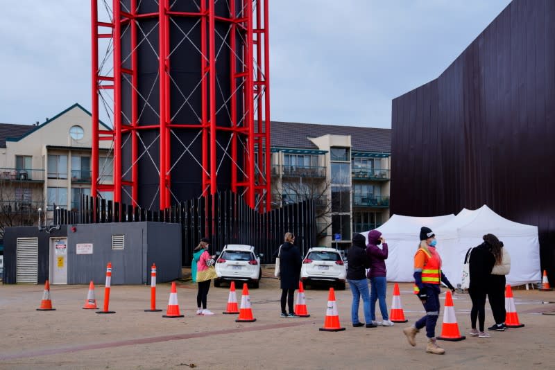 People wait to be tested at an apartment complex locked down in response to a COVID-19 outbreak in Melbourne