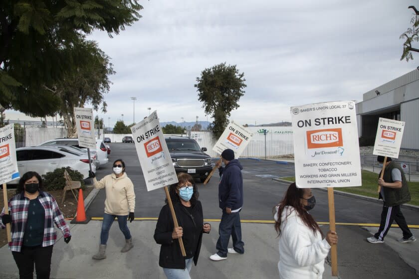 Workers at Jon Donaire Desserts factory in Santa Fe Springs picket in front of the company Monday.