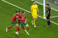 Morocco's players celebrate after winning a penalty shootout at the World Cup round of 16 soccer match between Morocco and Spain, at the Education City Stadium in Al Rayyan, Qatar, Tuesday, Dec. 6, 2022. (AP Photo/Abbie Parr)