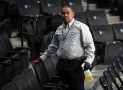 A worker disinfects seats prior to the start of the second round of the 2020 Atlantic 10 men's basketball tournament at Barclays Center on March 12, 2020 in the Brooklyn borough of New York City. The tournament was canceled amid growing concerns of the spread of Coronavirus (COVID-19). (Photo by Mike Lawrie/Getty Images)