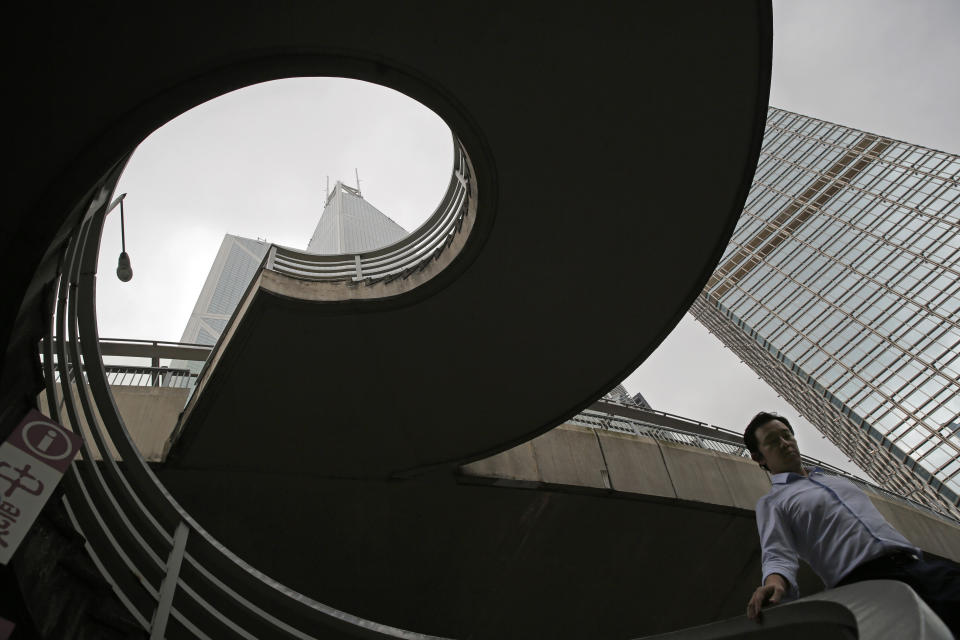 In this July 10, 2019, photo, a man walks on a bridge near the Bank of China Tower at Central, a business district of Hong Kong. It’s still the world’s “freest” economy, one of the biggest global financial centers and a scenic haven for tycoons and tourists, but the waves of protests rocking Hong Kong are exposing strains unlikely to dissipate as communist-ruled Beijing’s influence grows. (AP Photo/Kin Cheung)