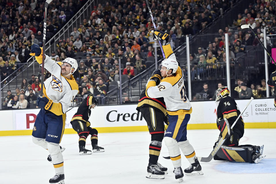 Nashville Predators left wing Filip Forsberg (9) and center Ryan Johansen (92) react after a goal against the Vegas Golden Knights during the third period of an NHL hockey game Saturday, Dec. 31, 2022, in Las Vegas. (AP Photo/David Becker)