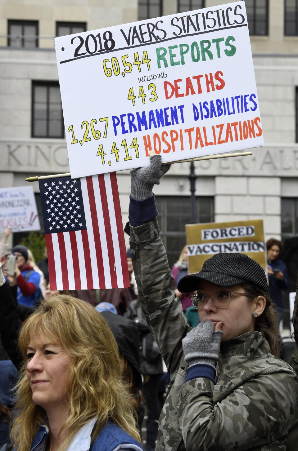 Demonstrators stand in the rain while protesting against legislation to narrow exemption to state-mandated vaccines at a rally at the state Capitol on Tuesday. (Photo: ASSOCIATED PRESS)