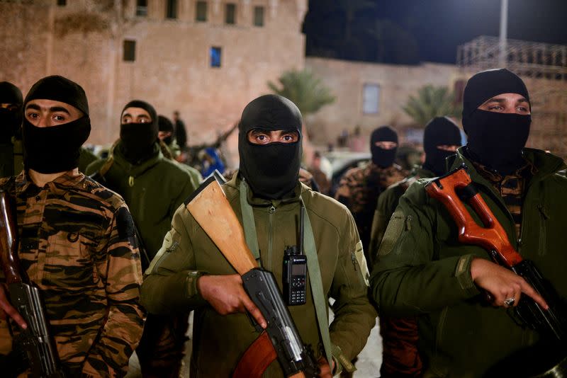 FILE PHOTO: Members of the military personnel arrive to take part in a parade calling for parliamentary and presidential election, in Tripoli