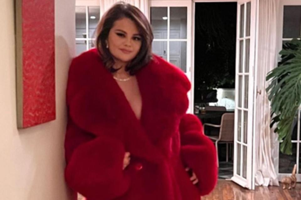 <p>Selena Gomez/Instagram</p> Selena Gomez wears a red statement coat for a night out to boyfriend Benny Blanco