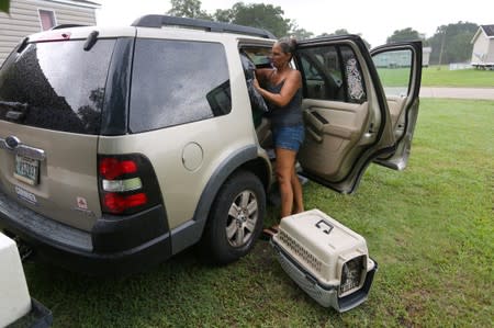 Amy Vasquez packs her car with belongings as Tropical Storm Barry approaches land in Port Sulphur