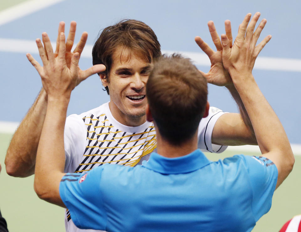 German Tommy Haas, left, and Florian Mayer celebrate during a Davis Cup World Group first round tennis match between Germany and Spain in Frankfurt, Germany, Saturday, Feb. 1, 2014. Germany has now a 3-0 lead and advances to the next round. (AP Photo/Michael Probst)