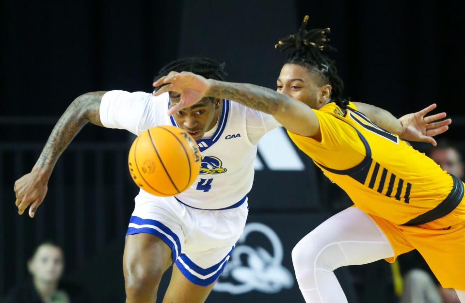 Delaware's Niels Lane (left) moves for a loose ball against North Carolina A&T's Uchenna Kellman-Nicholes in the second half of Delaware's 90-71 win at the Bob Carpenter Center, Thursday, Jan. 25, 2024.