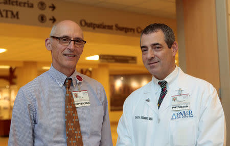 Dr. David Steinberg, Chief of Staff, Saint Joseph Mercy Health System and Dr. Steven Thiry, former chair, Dept of Family Medicine stand together in the lobby of Saint Joseph Mercy hospital in Ypsilanti, Michigan, U.S., August 23, 2017. Picture taken August 23, 2017. REUTERS/Rebecca Cook