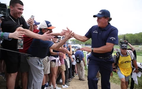 Phil Mickelson of the United States greets fans on the 17th hole during the final round of the 2019 PGA Championship at the Bethpage Black course  - Credit: Getty images