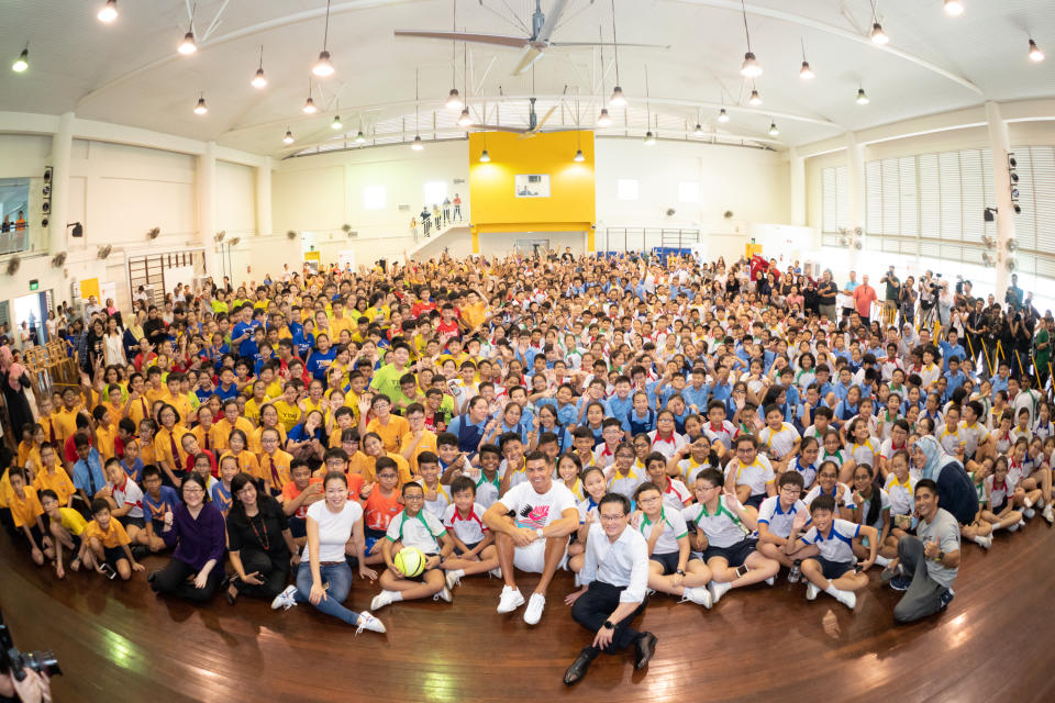 Football superstar Cristiano Ronaldo taking a group photo with the schoolchildren during his visit of Yumin Primary School. (PHOTO: Singapore Olympic Foundation-Peter Lim Scholarship)