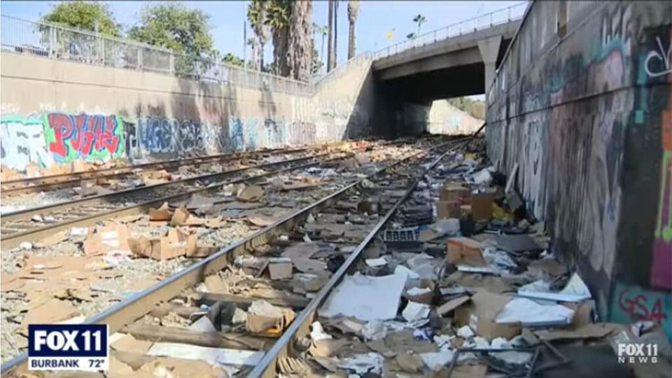 Looted packages litter a stretch of Union Pacific railroad tracks in Los Angeles. (YouTube/Fox 11 LA)