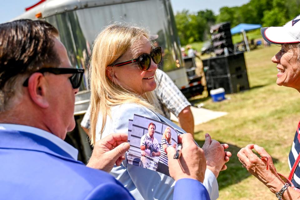 Mark McCloskey, left, and his wife, Patricia, sign autographs for Colleen Jakubowski, right, of Grand Rapids, during the 'Defend our 2A: Michigan's Right for Self Preservation' event on Wednesday, July 19, 2023, at Freedom Farms in Ionia Township. Mark McCloskey, who spoke at the event, and his wife were photographed outside their St. Louis home with guns during the George Floyd protests in 2020.
