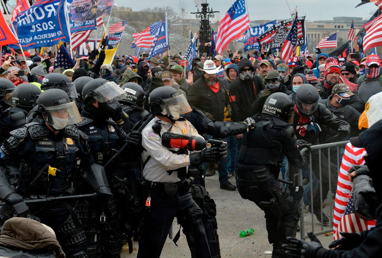 <p>Pro-Donald Trump rioters clash with police outside the US Capitol building, which some of them stormed after breaking windows and overrunning police. One woman died.</p> (JOSEPH PREZIOSO/AFP via Getty Images)