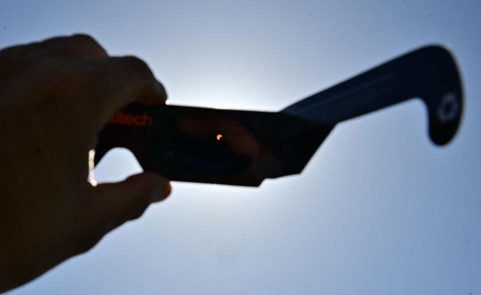 A solar eclipse viewed through eclipse glasses