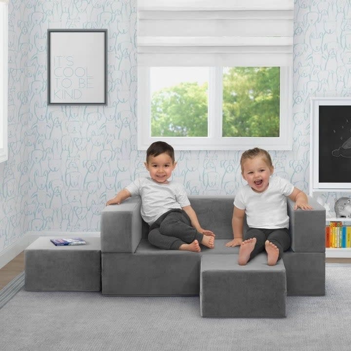 Kids sit on a play couch