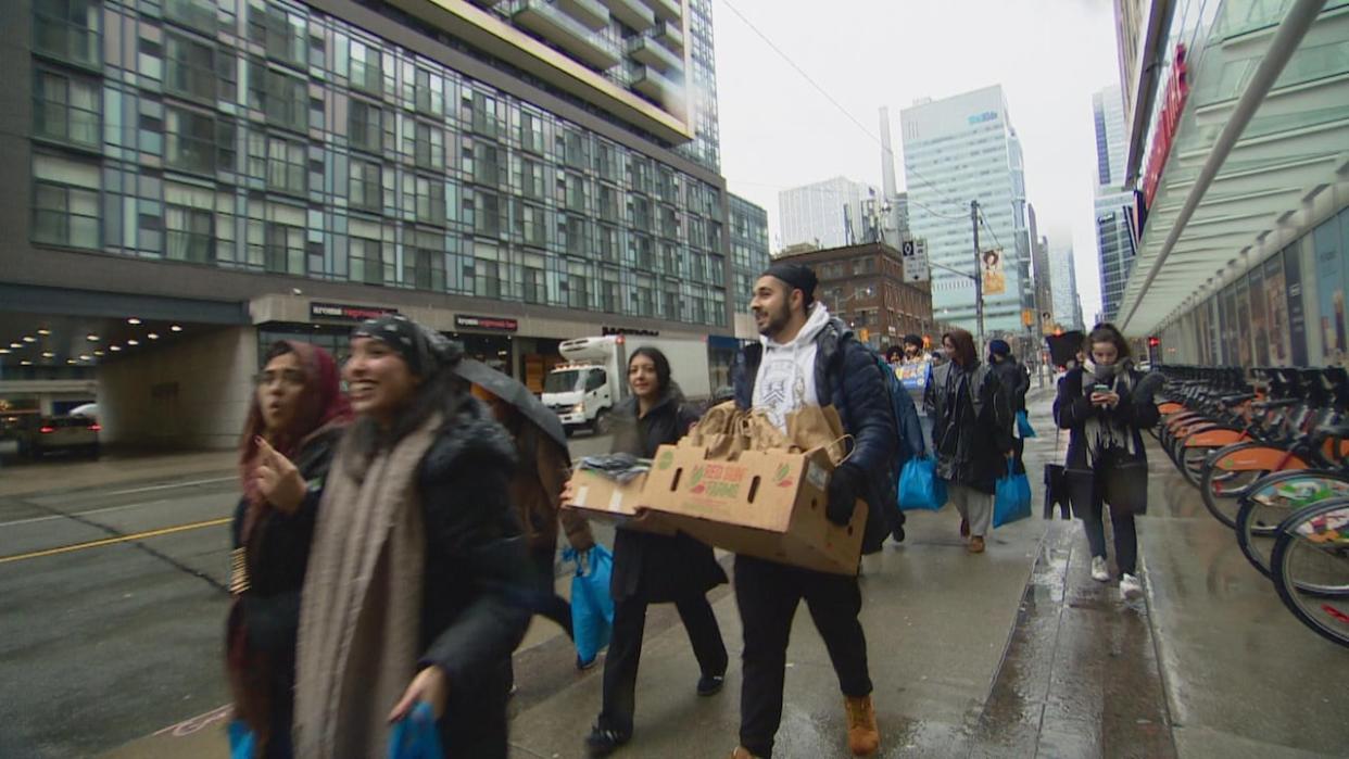 Over 250 students from across the GTA distributed packages to homeless people in downtown Toronto. (CBC - image credit)