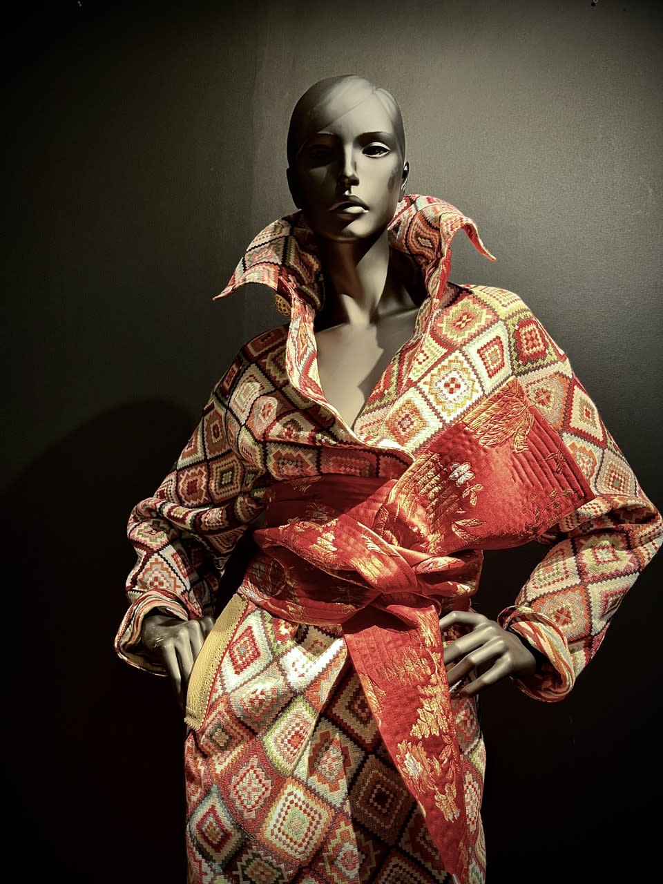 A wool brocade coat with padded obi belt by Albrecht Ollendiek.