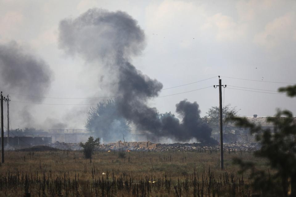 FILE - Smoke rises over the site of explosion at an ammunition storage of the Russian army near the village of Mayskoye, Crimea, Tuesday, Aug. 16, 2022. Russia's Black Sea Fleet has suffered heavy damage from Ukrainian drone and missile attacks. (AP Photo/File)