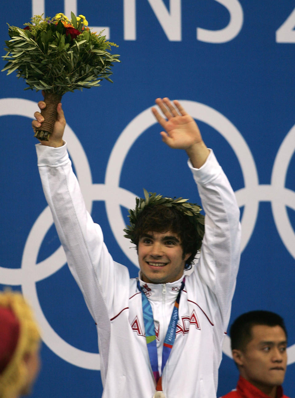 ATHENS - AUGUST 24: Alexandre Despatie of Canada celebrates after receiving the silver medal at the men's diving 3 metre springboard medal ceremony on August 24, 2004 during the Athens 2004 Summer Olympic Games at the Aquatic Centre Indoor Pool at the Olympic Sports Complex in Athens, Greece. (Photo by Daniel Berehulak/Getty Images for FINA)